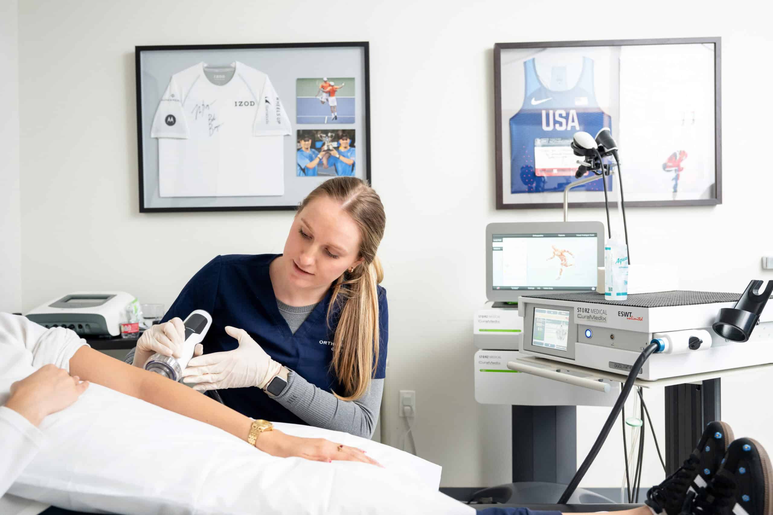 Orthohealing medical employee performing shockwave therapy for chronic pain relief