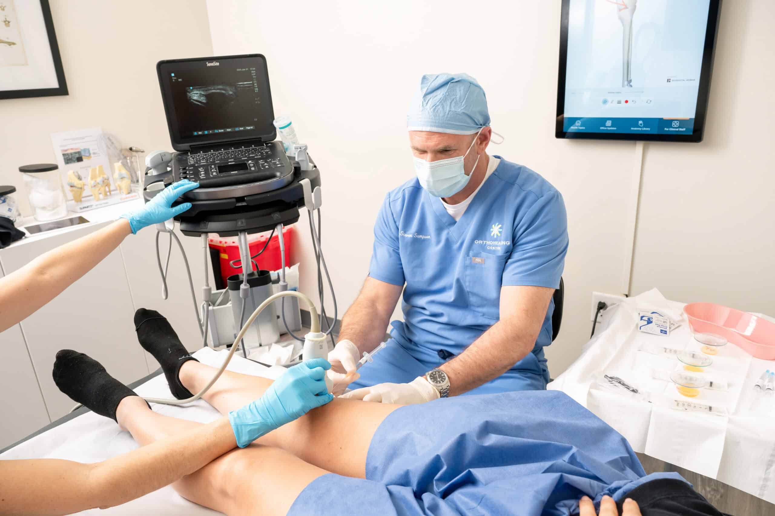 Dr. Steven Sampson performing bone marrow cell therapy on a patient to reduce chronic pain